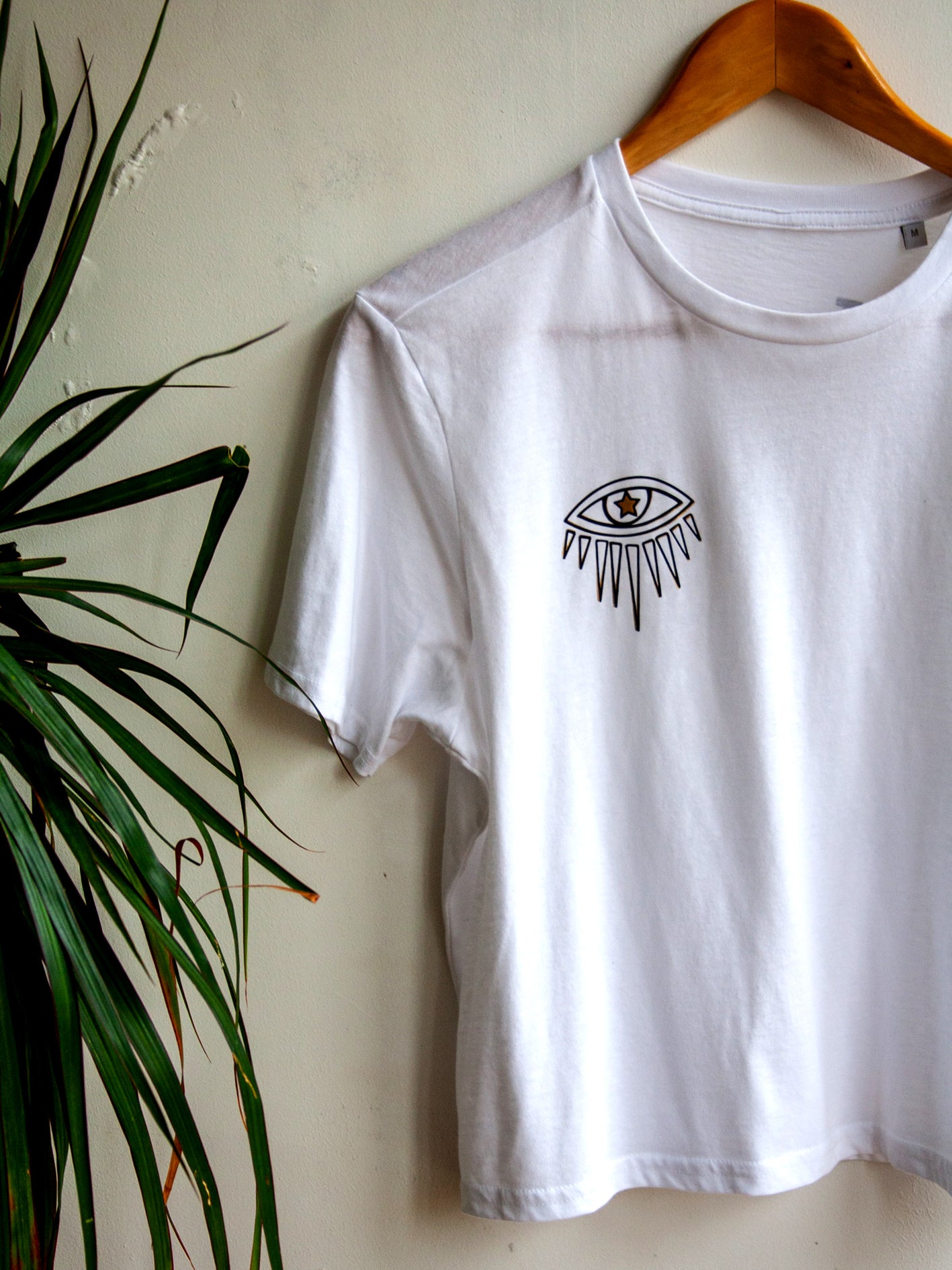 White Eye T-shirt with Black and Gold Design