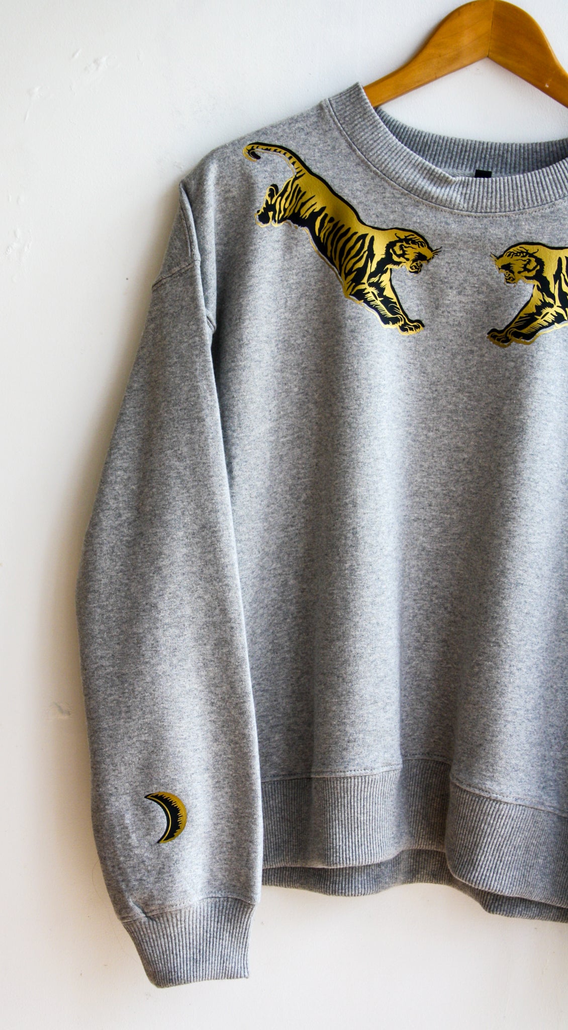 Grey sweater with black and gold flying tigers