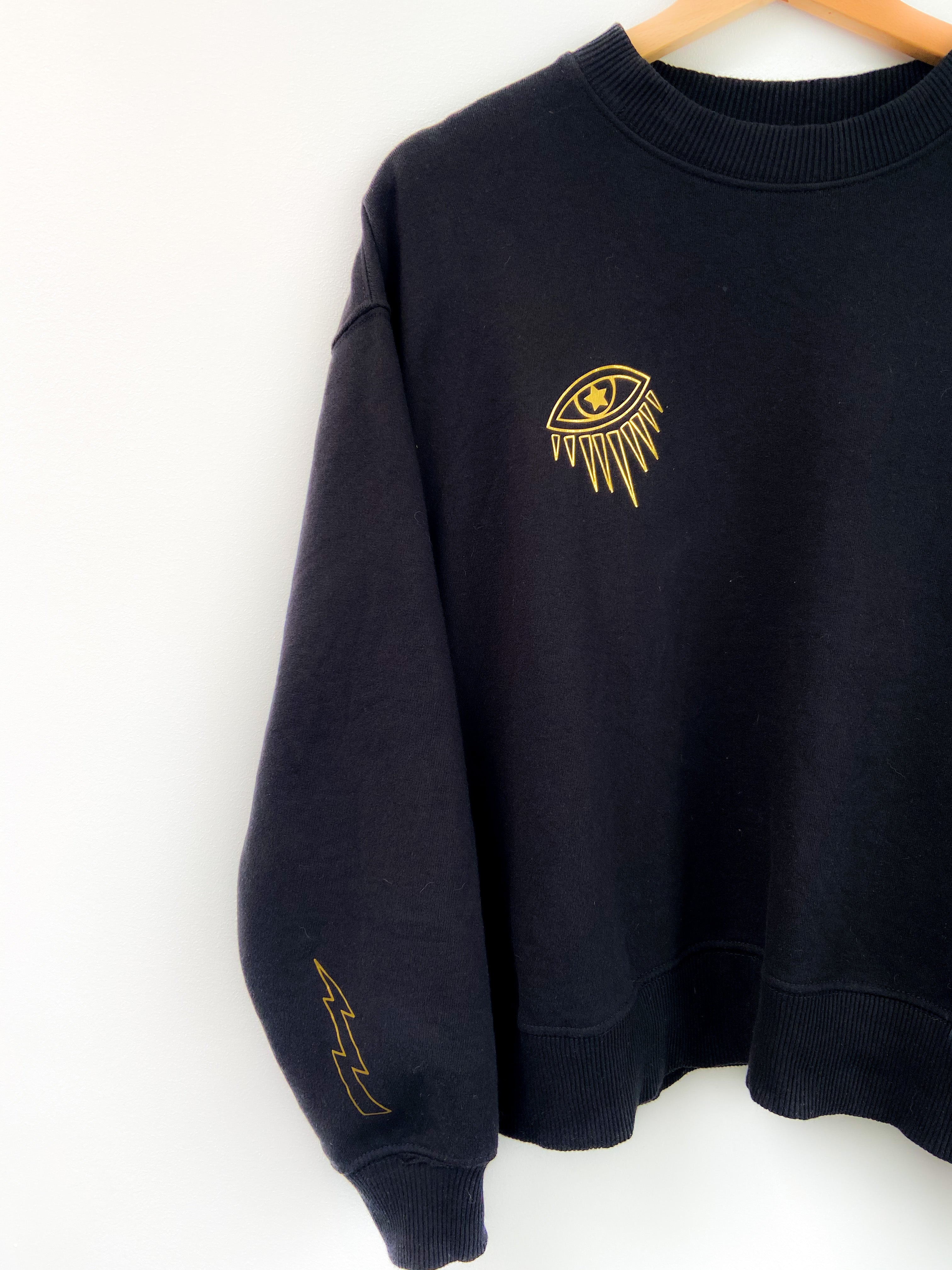 Black sweater with gold eye