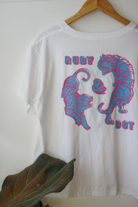 White T-shirt with pink and blue circling tigers on back