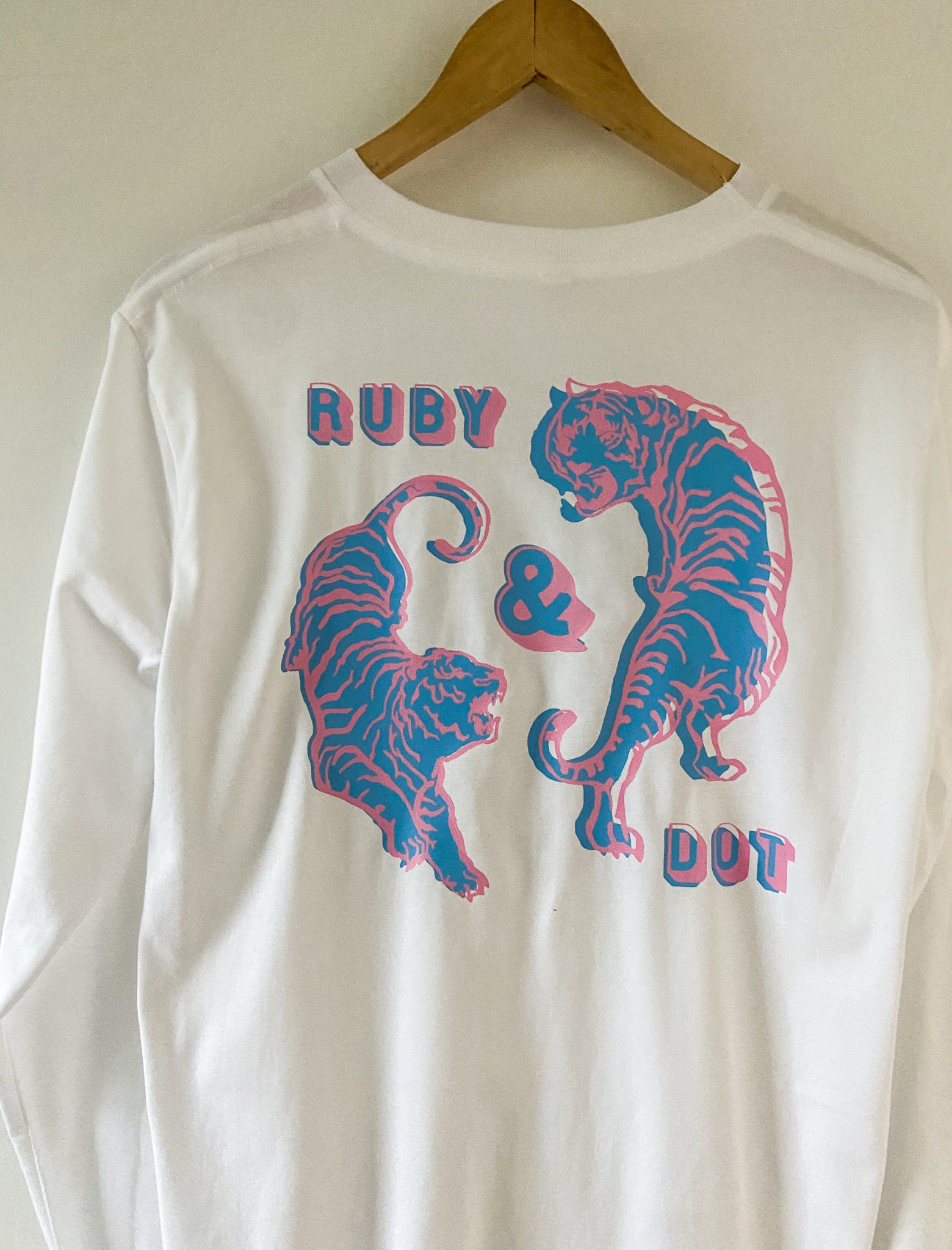 White long Sleeve top with back design of circling pink and blue tigers